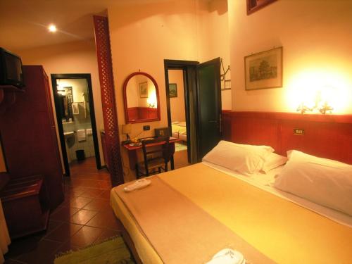 a hotel room with a bed and a bathroom at Hotel Toledo in Naples