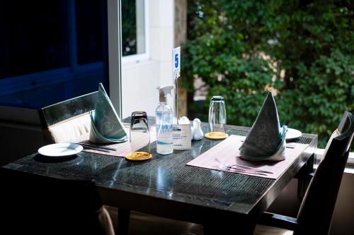 a black table with a bottle and glasses on it at Airside Hotel in Accra