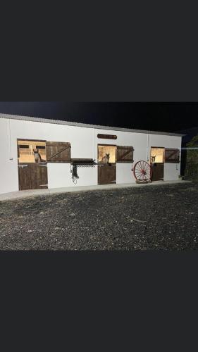 a white building with pictures on the side of it at Toddys Cottage & Stables in Cavan