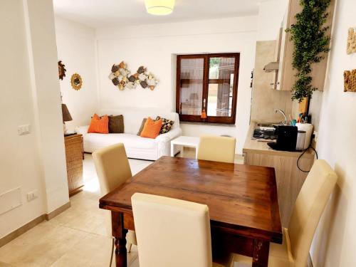 a living room with a wooden table and chairs at Sperlonga Shores in Sperlonga