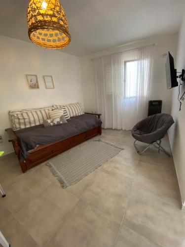 a bedroom with a bed and a chair in it at Espacio Edison 1 in Santa Rosa