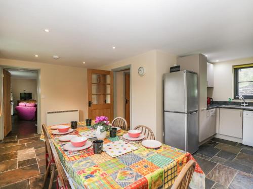 a kitchen with a table and a refrigerator at Nine Acres Barn in Marlborough