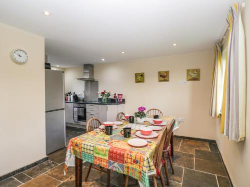 a kitchen and dining room with a table and chairs at Nine Acres Barn in Marlborough