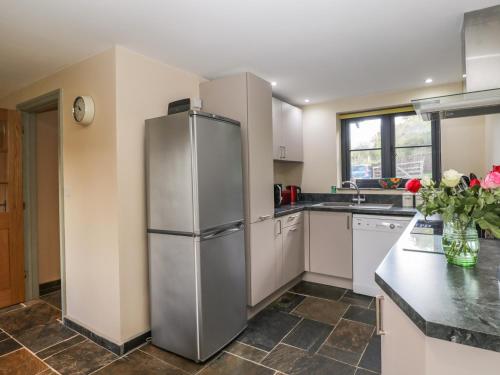 a kitchen with a stainless steel refrigerator at Nine Acres Barn in Marlborough
