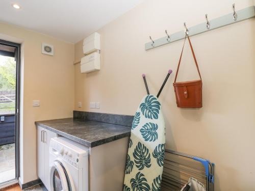 a laundry room with a washer and dryer at Nine Acres Barn in Marlborough