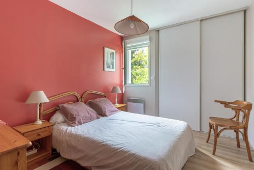 a bedroom with a bed and a desk and a window at Les Rives de L'Erdre in Nantes