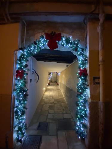 an arch decorated with christmas lights and a bow at Supriani Luxury B&B in Acquaviva delle Fonti