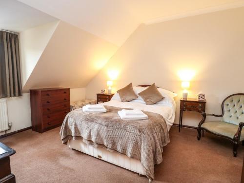 a bedroom with a bed with two towels on it at Walnut Tree Cottage in Great Yarmouth