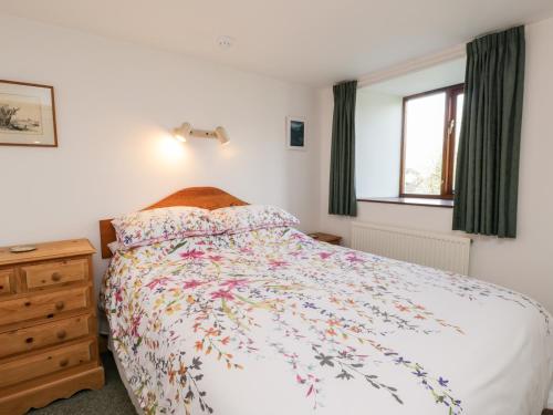 a bedroom with a large bed and a window at Gateside in Pickering