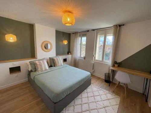 1 dormitorio con cama y ventana grande en L'Appartement Vert, en Douai