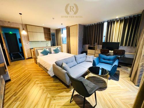 a hotel room with a bed and a couch and chairs at River View Hotel in Ho Chi Minh City