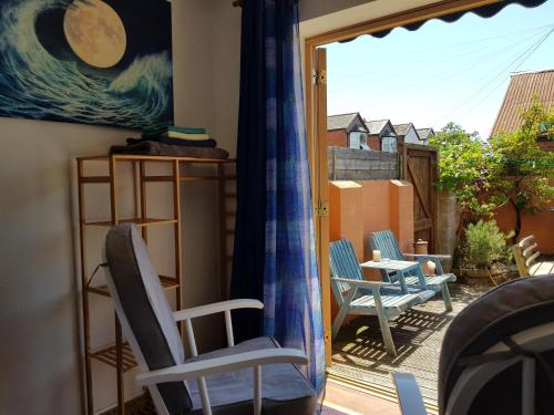 a balcony with chairs and a view of the ocean at Garden room in Exmouth