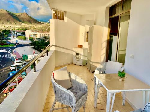a balcony with a table and a view of a city at Cozy apartament Los Cristianos in Arona