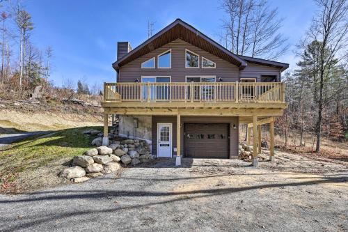 a large house with a deck on top of it at Chestertown Hideaway with Lake and Beach Access! in Chestertown