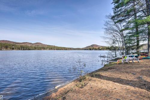 a view of a lake with chairs on the shore at Chestertown Hideaway with Lake and Beach Access! in Chestertown