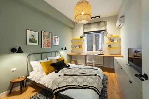 a bedroom with a bed and a desk and a window at Bohemian Apartment in Old Town - Self Check-in in Bucharest