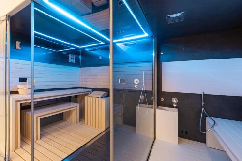a sauna with blue lighting in a room at LUSTER Hotel in Lisbon