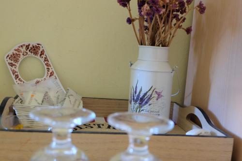 a vase with flowers in it sitting on a shelf at Hostel il Tetto in Melfi