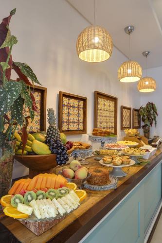 a buffet with many different types of food on a table at Solar Beach Hotel in Florianópolis