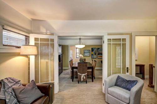 a living room with a table and a chair at Charming 2Bed French Colonial Apartment in Desirable Midtown Sacramento in Sacramento