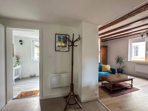 a living room with a table and a room with a couch at nouvel appartement, Le Colombage Heureux in Sélestat