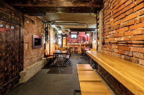 a room with a brick wall and wooden benches at Wadowice Apartamenty Nad Skawą in Wadowice