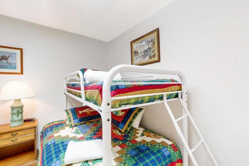 a bedroom with two bunk beds and a lamp at A Kerr Home in Moneta