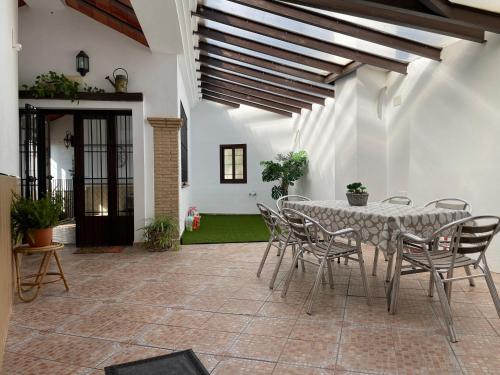 un patio con mesa y sillas en una casa en Casa Asador Sierra De Aracena, en Aracena
