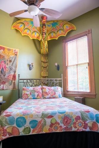 a bedroom with a bed with a dragon head on the wall at The Lookout Inn in New Orleans
