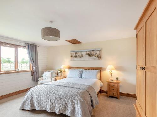 a bedroom with a large bed and a window at The Nook in Louth