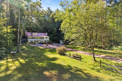 an aerial view of a house in the woods at 6 Bedroom House at Schroon River in Brant Lake