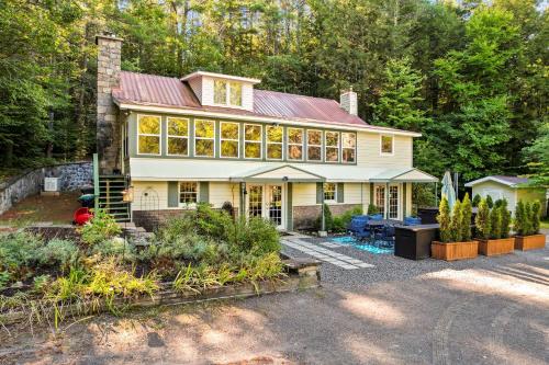 a large white house with a lot of windows at 6 Bedroom House at Schroon River in Brant Lake