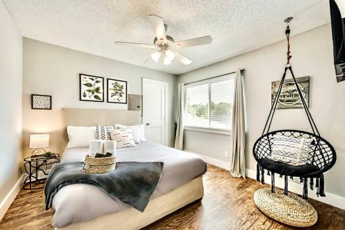 a bedroom with a large bed with a swing at Lovely Dallas Flat Near Downtown in Dallas
