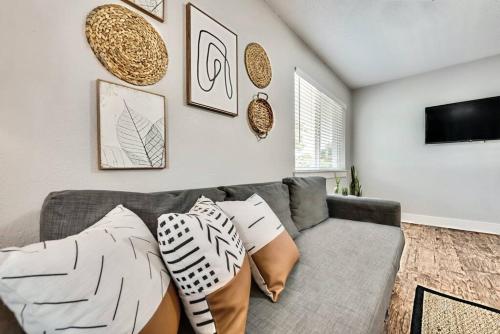 a living room with a gray couch with pillows at Global Cup Lovely Dallas Flat Near Downtown in Dallas