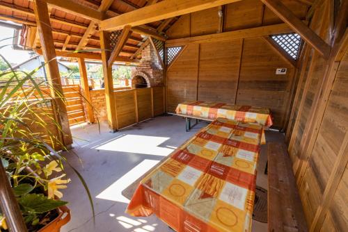 two beds in the inside of a wooden cabin at Apartments Galunder in Veržej