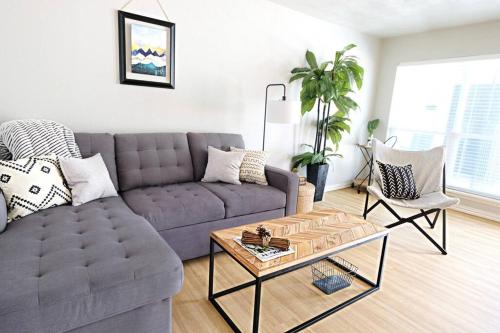 a living room with a couch and a coffee table at Global Cup The City Escape & Arboretum Tickets Included in Dallas