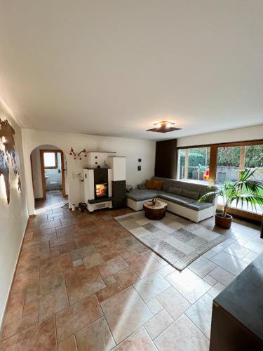 a large living room with a couch and a fireplace at Apartment Malea in Schlitters