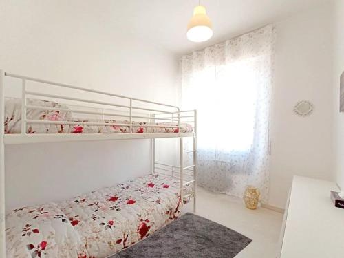 a bedroom with a bunk bed and a window at La reggia del mar - Genova Sturla, mare e Gaslini in Genova