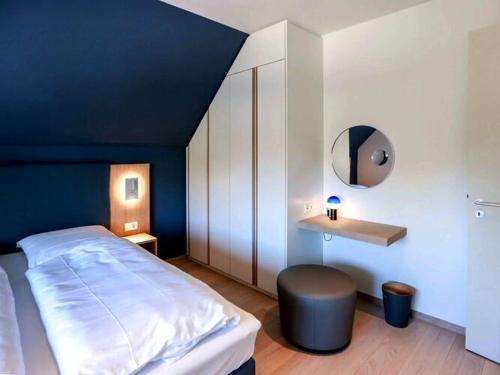 a bedroom with a large bed and a blue ceiling at Exklusives Landhaus auf Fehmarn in Schlagsdorf