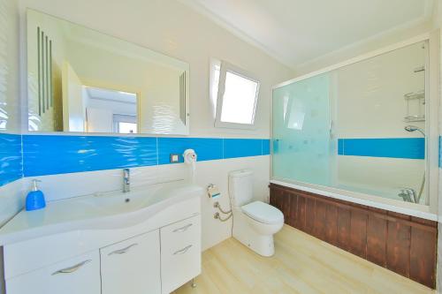 a bathroom with a white sink and a toilet at James Pansiyon Blue sea view villas Kaş Peninsula in Kas