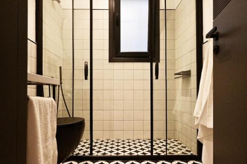 a bathroom with a shower with a toilet and a window at Architect's Art House right on Taksim Square in Istanbul
