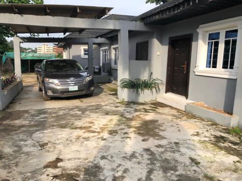 a car parked in front of a house at Charming & Cozy 1-BDR Apt - Mini Flat - 247 Power, Kitchen, Wi-Fi, DSTV, Netflix, 5 mins from the Airports in Ikeja