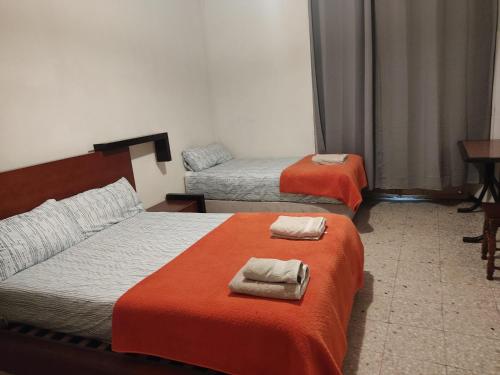 A bed or beds in a room at Hostal “ INFANTAS”