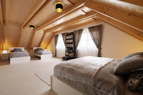 a bedroom with a large bed in a room with wooden ceilings at Chalupa Vojtěchov in Lísek