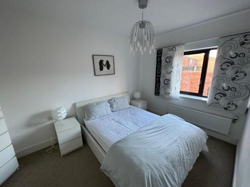 a white bedroom with a bed and a window at 2 Bedroom Riverside Property with Roof Terrace in Stockton-on-Tees