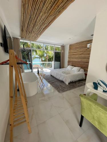 a bedroom with a bed and a view of the ocean at Casa La Joya Bacalar in Bacalar