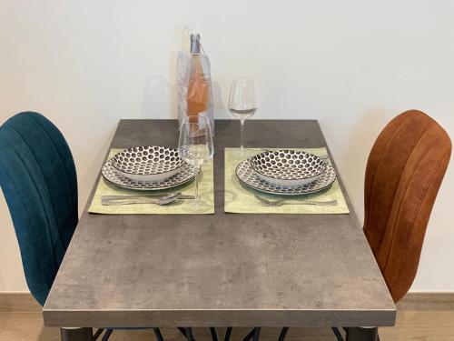a table with two plates and a glass of wine at L’annexe in Bastogne