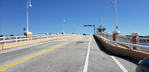a bridge over a road with a car on it at OCEAN VACATION BREEZE in Lantana