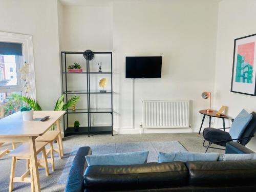 a living room with a couch and a table at The Seacroft in Southport