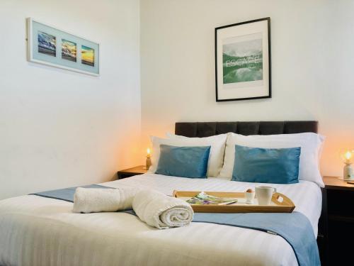 a bedroom with two beds with a tray on the bed at The Seacroft in Southport